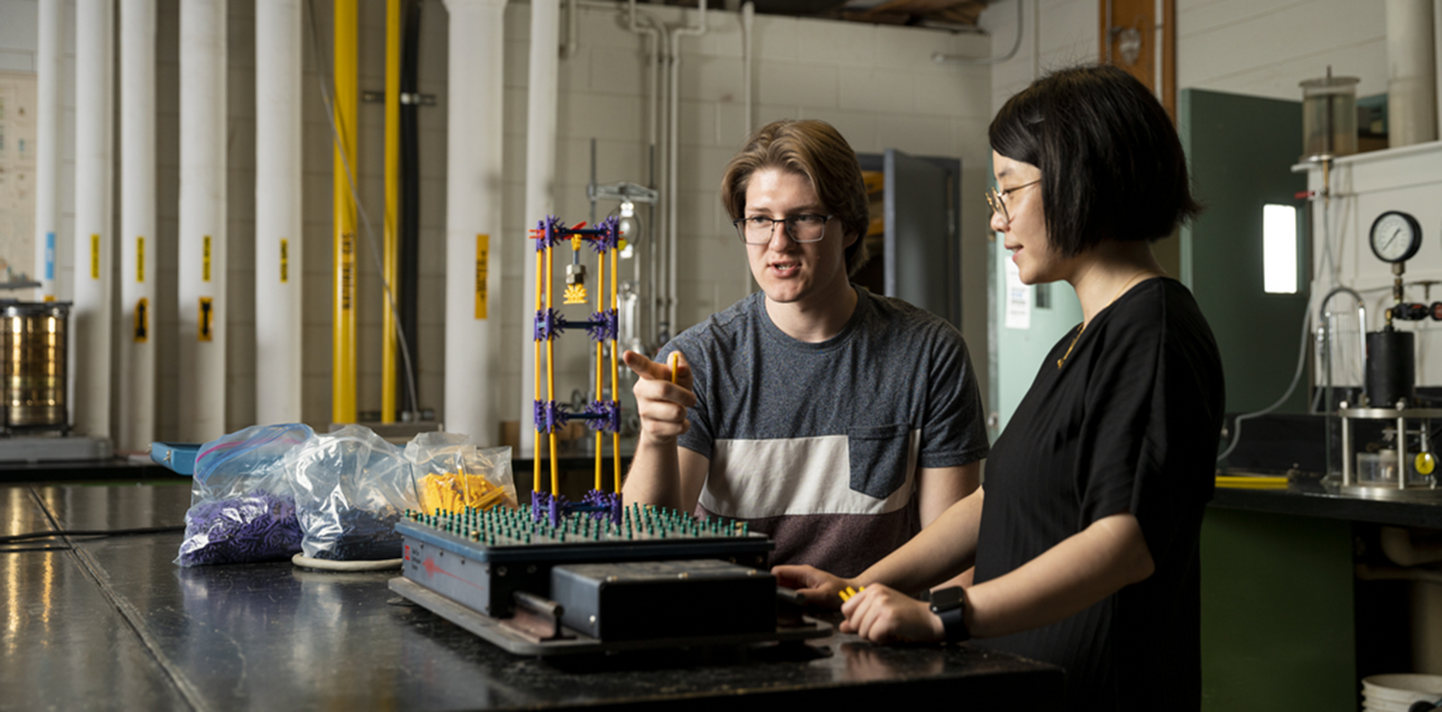 Researchers working with building rods to make a structure
