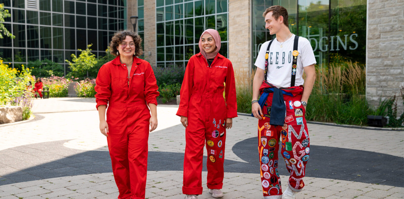 Redsuits walk in front of JHE.